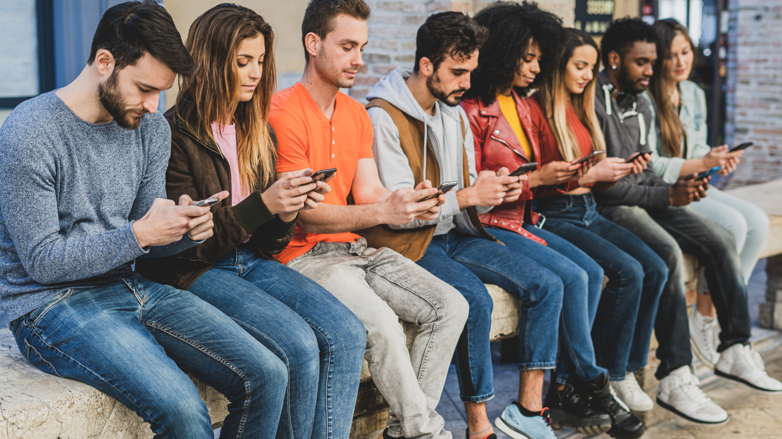 Group of young people looking at their phones