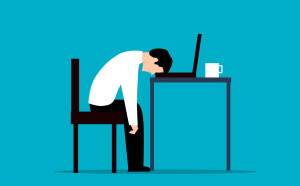Illustration of a sad office worker resting his head on the keyboard of his laptop