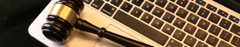 a gavel resting on a laptop keyboard