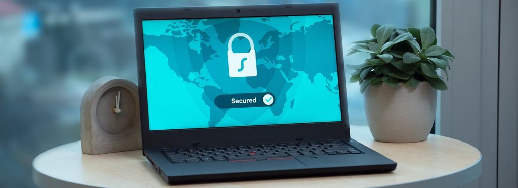 a laptop with graphic of security lock on screen