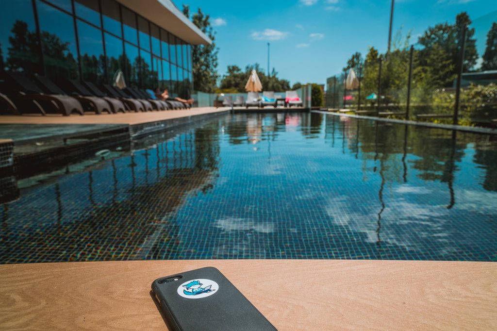 a phone sits next to a pool