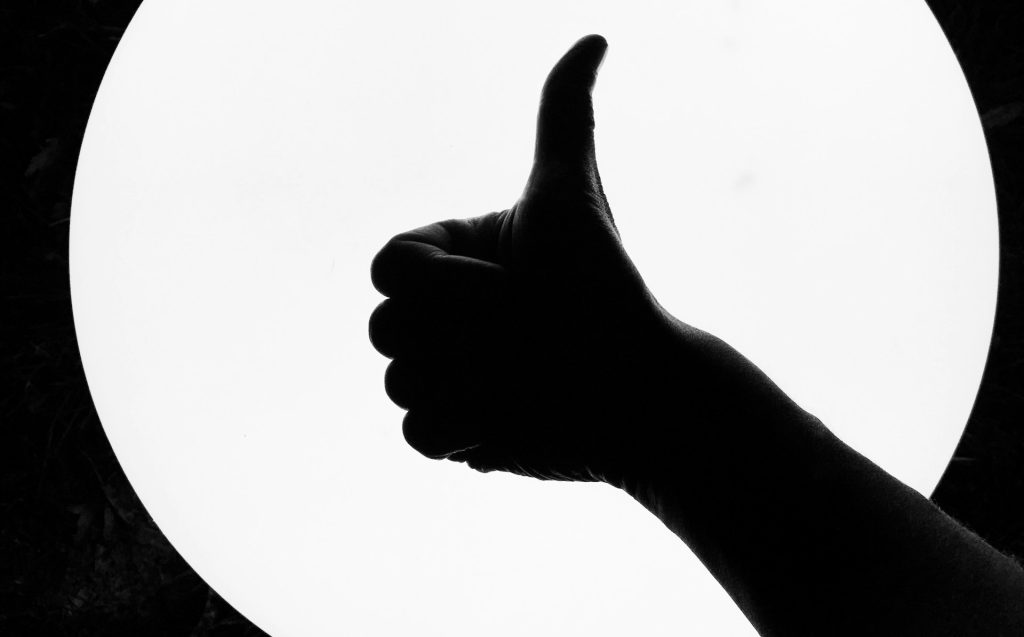 a thumbs up in silhouette
