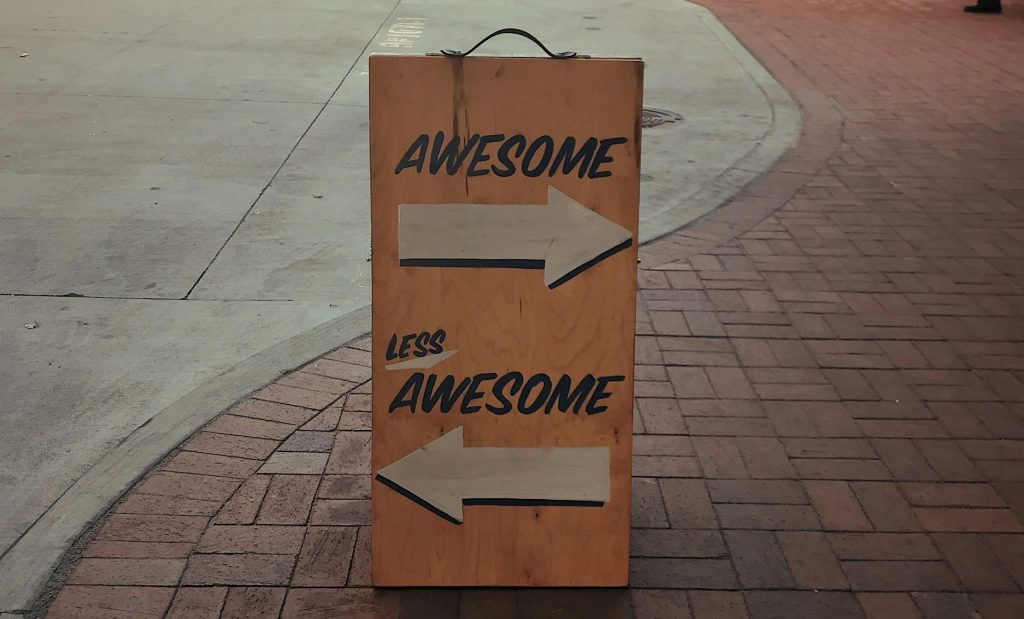 a sign that reads "awesome, less awesome"