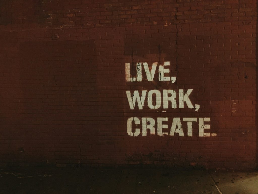 the words "live work create" painted on a wall